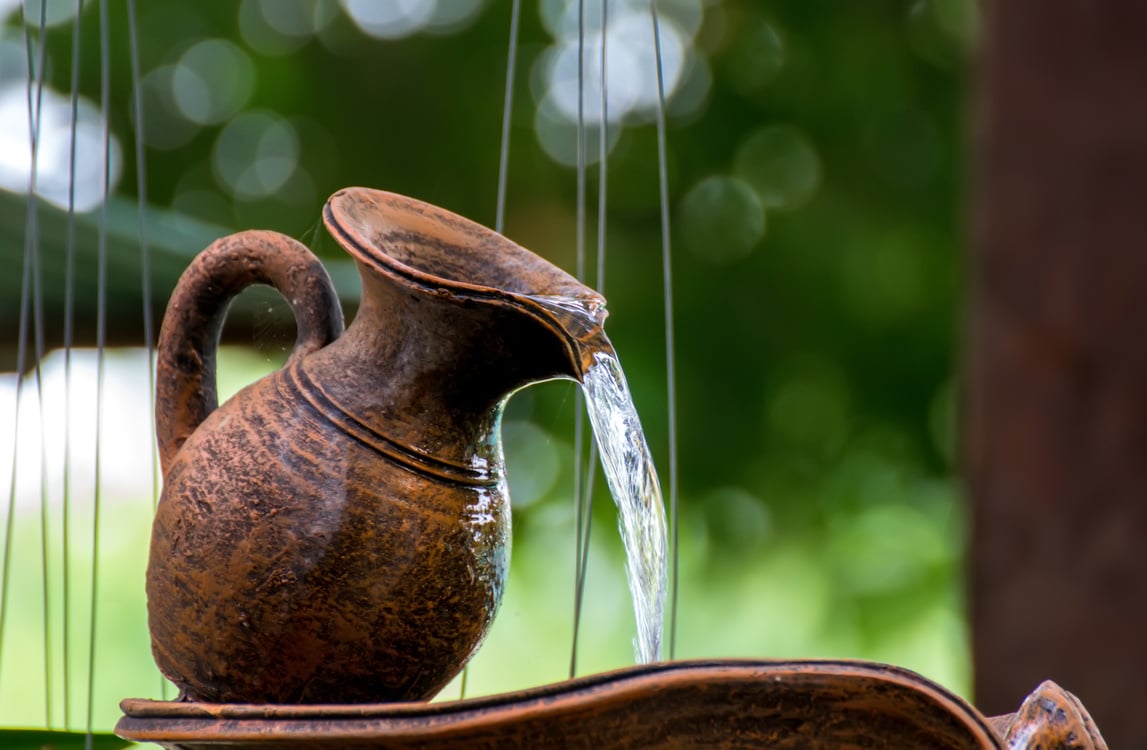 water is drop from clay jug in the garden.